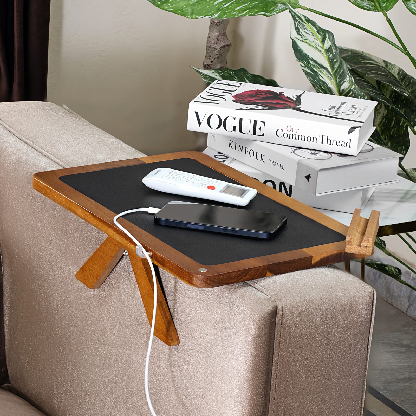 Phone charging on the tray with its cable routed through the built-in wire groove