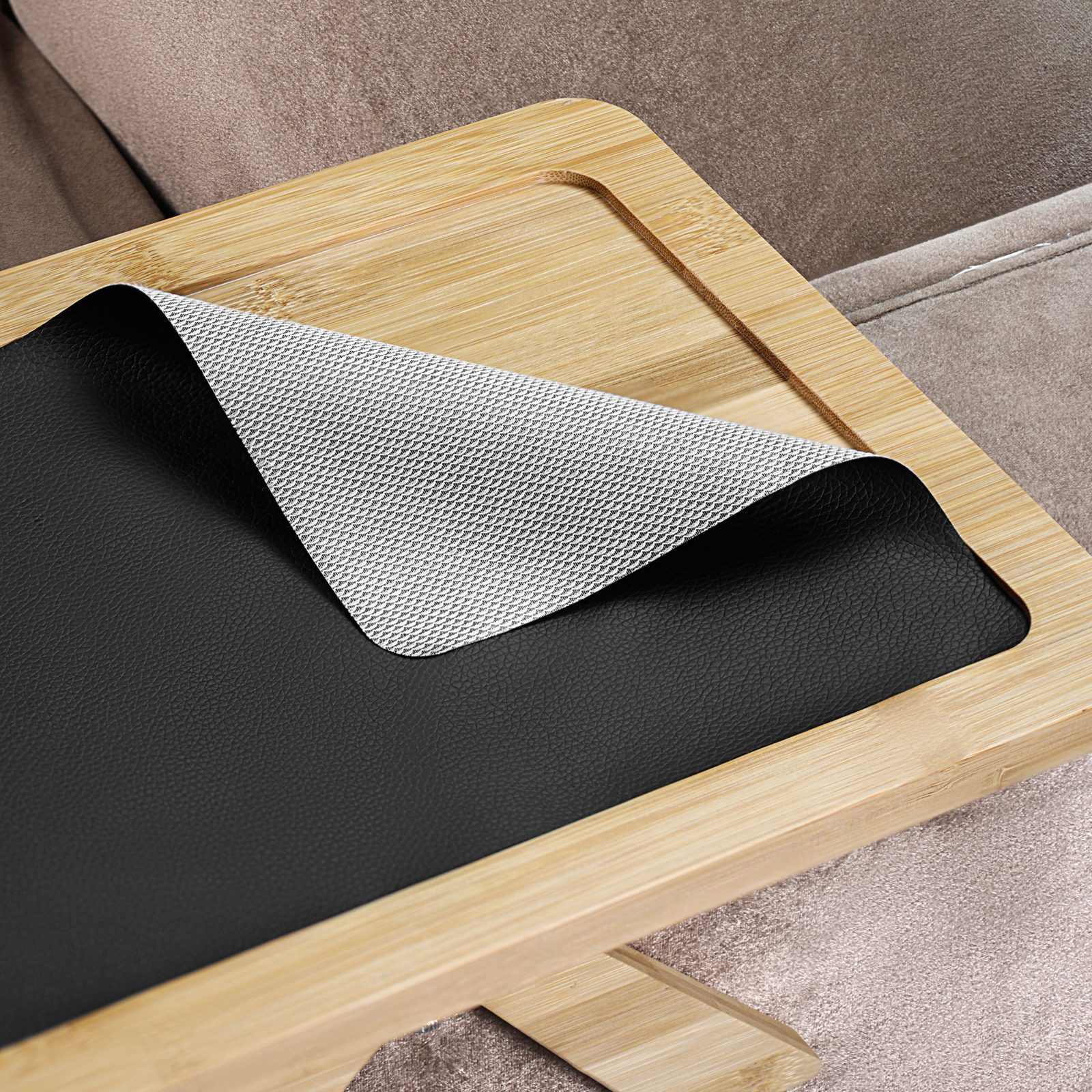 Removable non-slip mat lifted to show the bamboo tray surface underneath