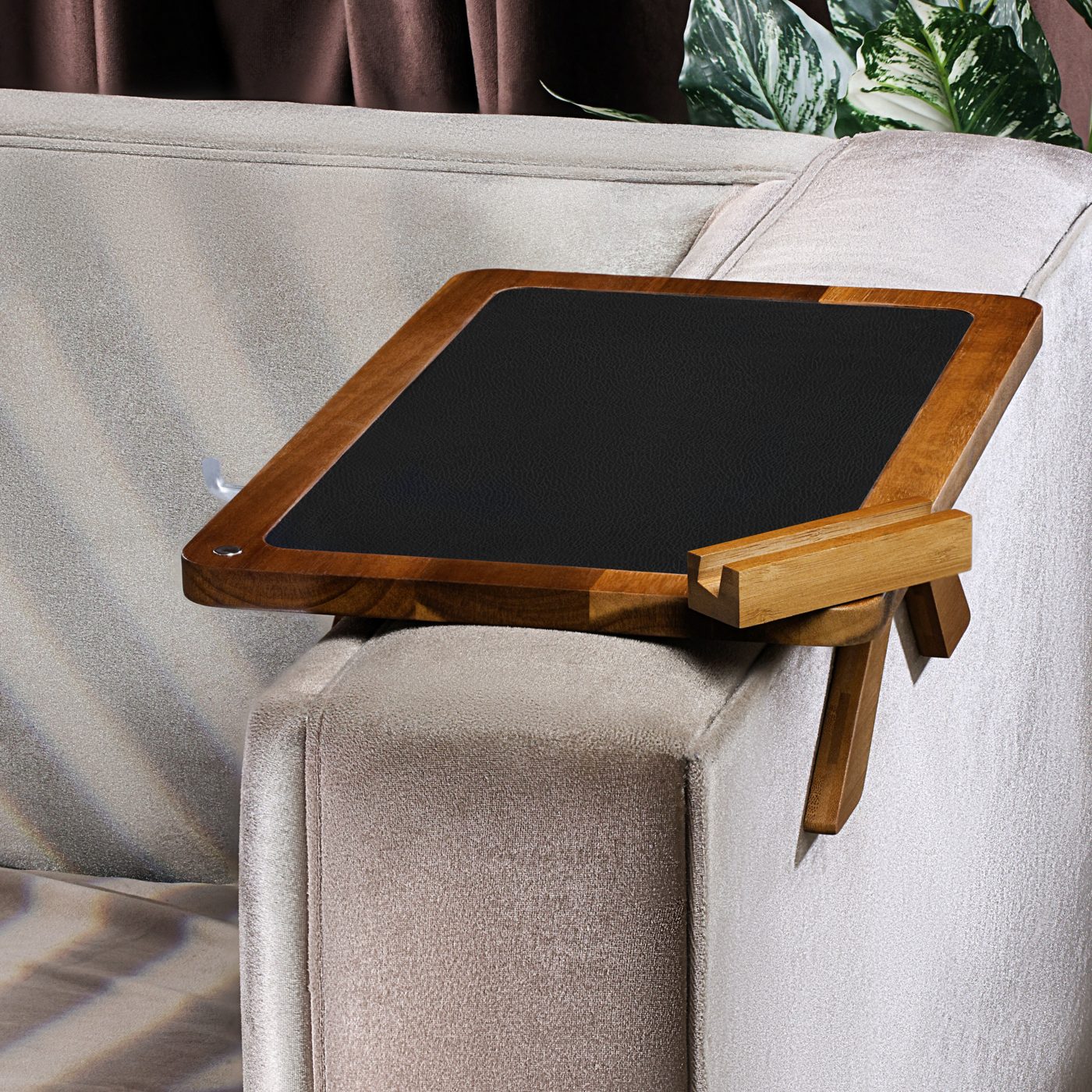 Acacia wood couch arm tray clamped on a sofa armrest
